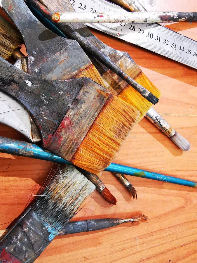 Artist dry brushes - paint brushes. Painter tools on the floor royalty free stock photos